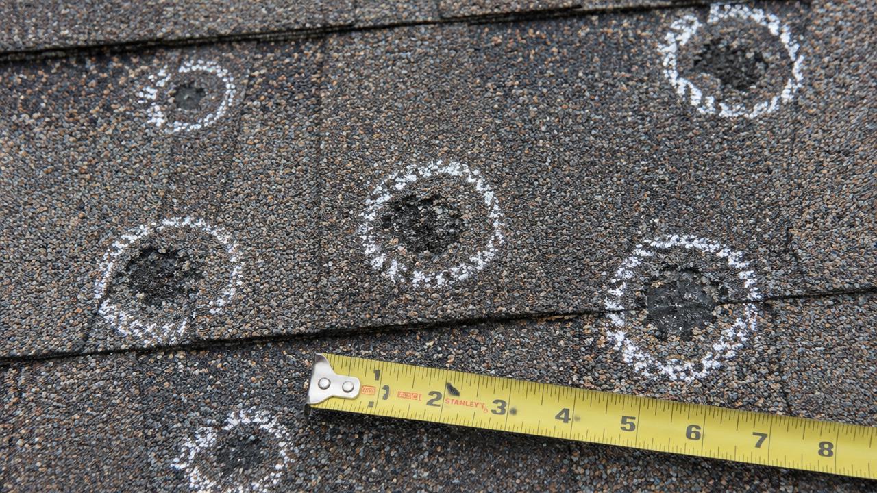 Hail hits circled in chalk: random bruises with granule loss, measured for scale.